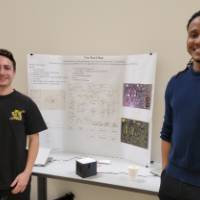 2 people in front of a senior project